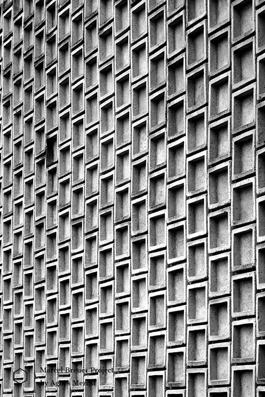 Close-up of the rhythmic concrete relief on the IBM Research Center's facade. The repetitive geometric patterns create a dramatic play of light and shadow, typical of Marcel Breuer's sculptural brutalism.