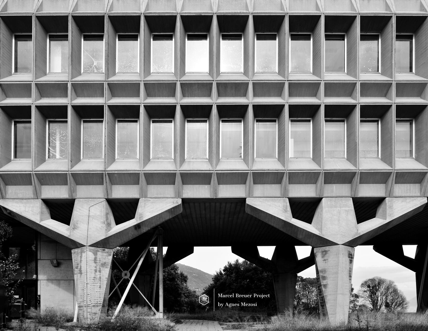 Marcel Breuer's IBM Research Center in La Gaude, France. Symmetrical view of the brutalist concrete facade supported by sculptural Y-shaped pilotis.