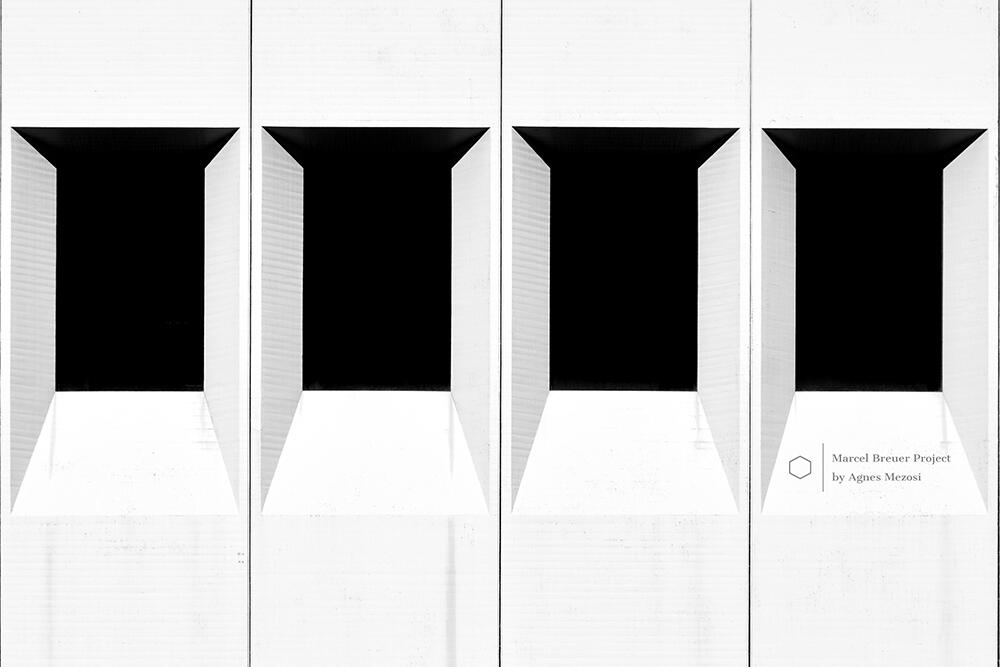 Symmetrical view of four rectangular window openings set into deep white concrete frames, demonstrating Breuer's modular architectural logic.