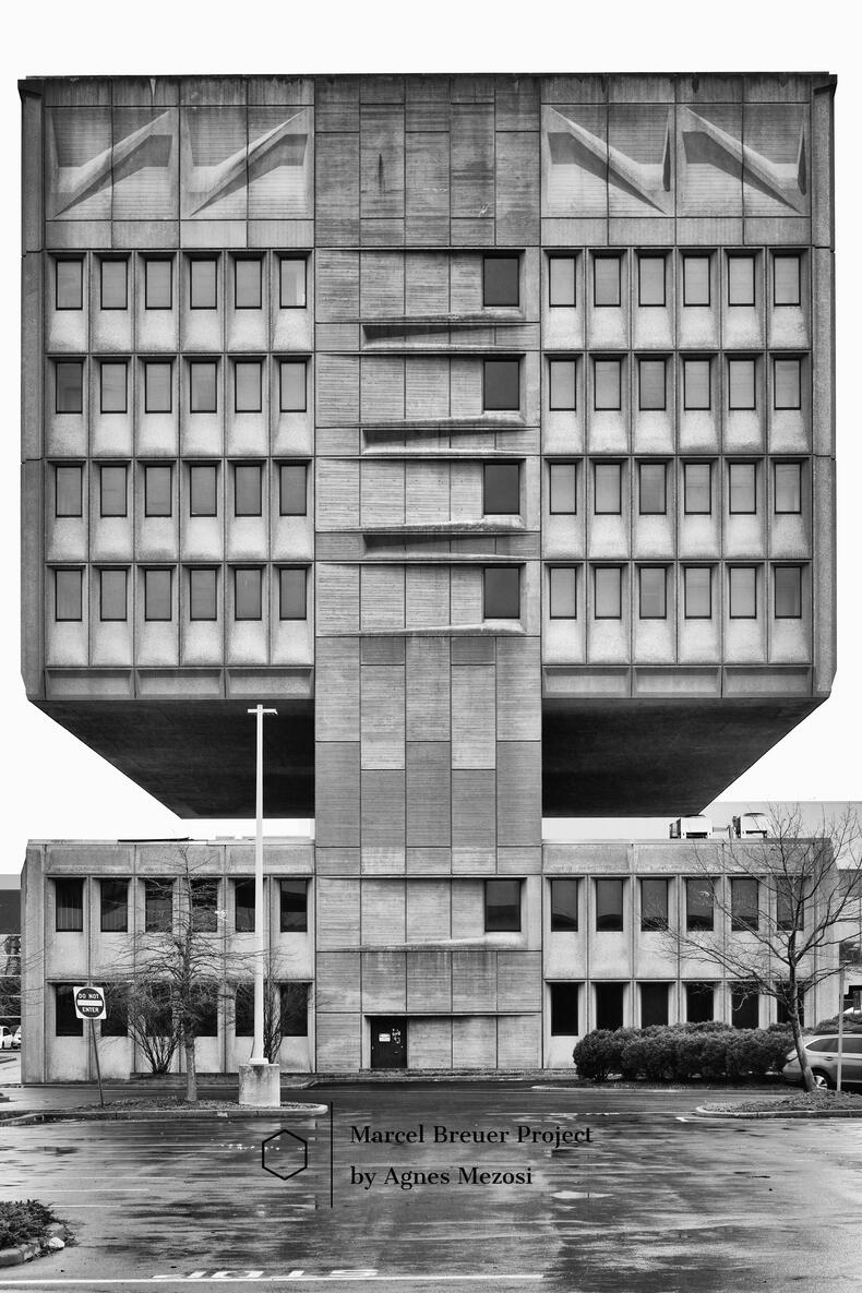 Exterior full-view photograph of the Armstrong Rubber Building in New Haven by Marcel Breuer, showing the unique construction where the upper office floors are separated from the lower levels by a massive open gap.