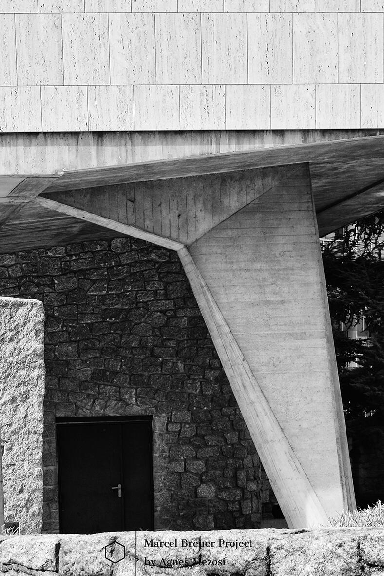 Close-up black and white photograph of a monumental, flared concrete support pillar (piloti) of the UNESCO building, showing its raw texture and geometric power.