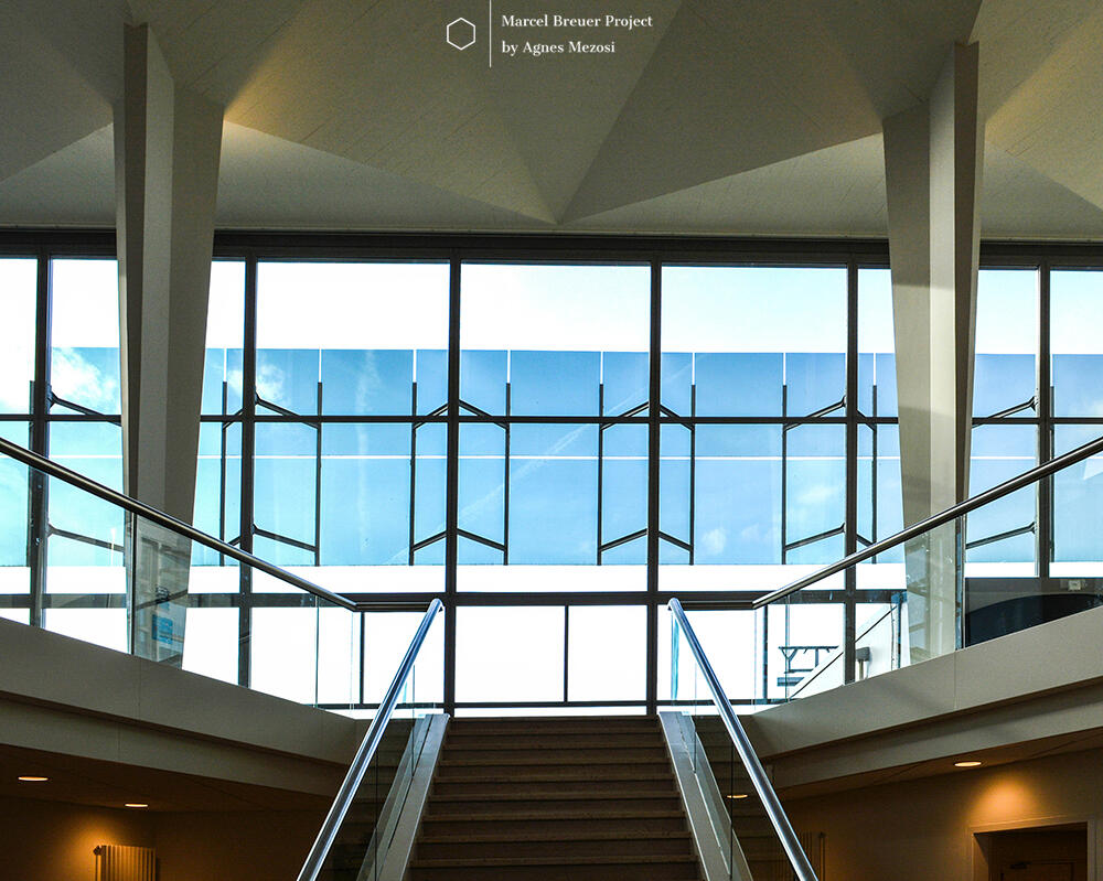 The interior reveals the complex geometry of the folded concrete roof, supported by central columns that allow for a completely column-free perimeter.